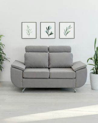 A gray two-seat sofa against a white wall
